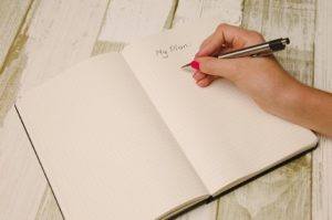 Woman writing my plan in notebook