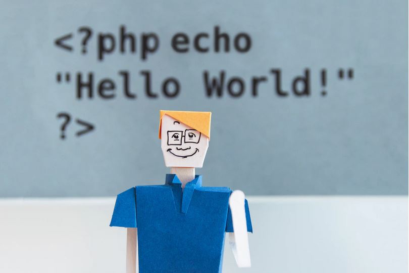 Translator or copywriter? Who should you choose? This image shows a waving cut-out man and the text "Hello World!"