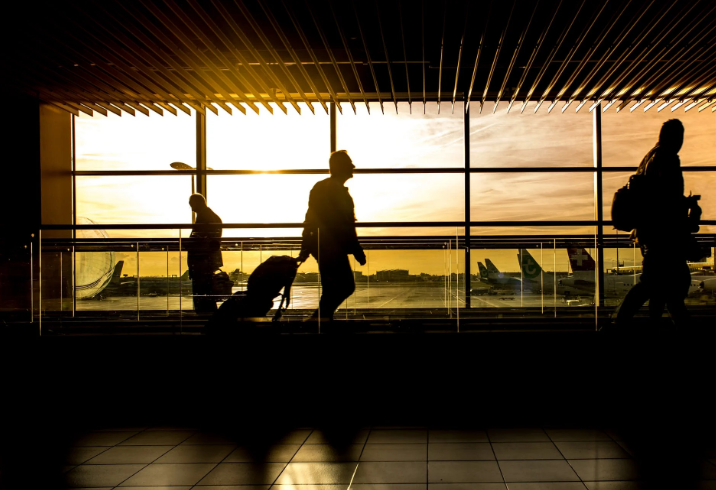 Travelers at the airport during sunset