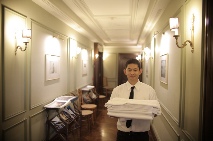 Housekeeping efforts will be a priority among New Normal Travelers. // This image shows housekeeping carrying folded linens.